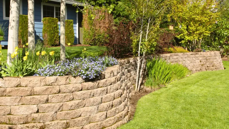 Segmental concrete-block retaining wall bordering a landscaped garden.